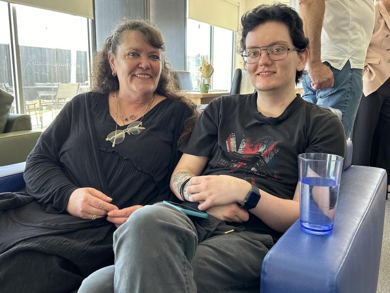 Two women sitting together smiling