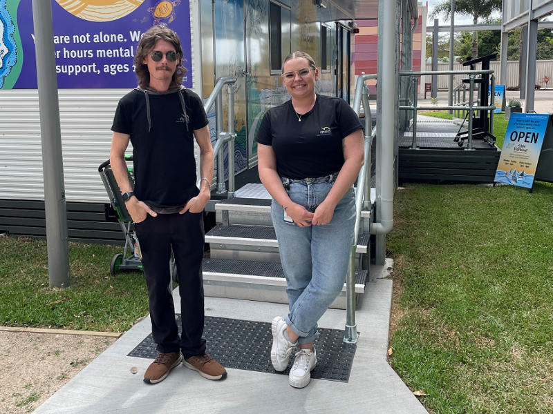 A man and woman standing outside a building
