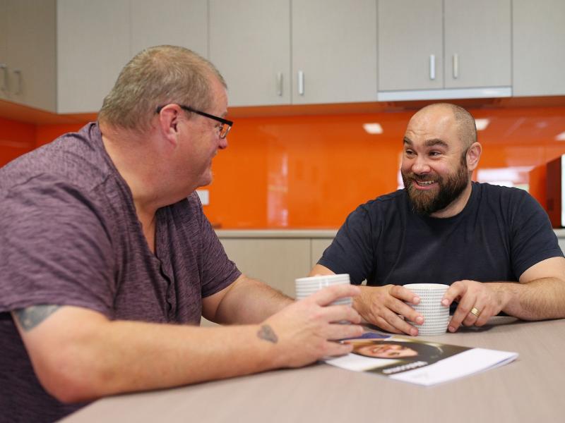 Two men chatting over coffee