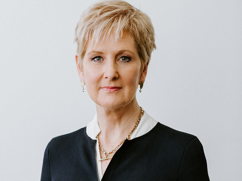 Gill in black jacket with serious face
