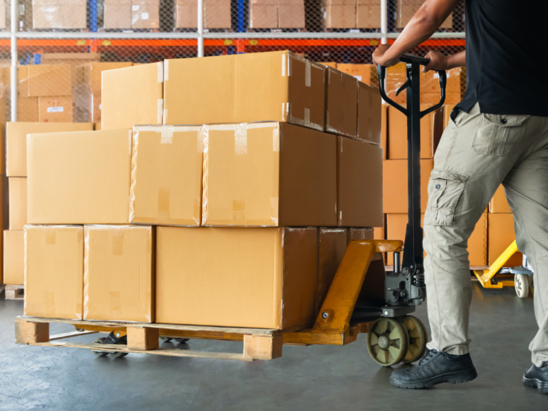 Man pushing a trolley with boxes