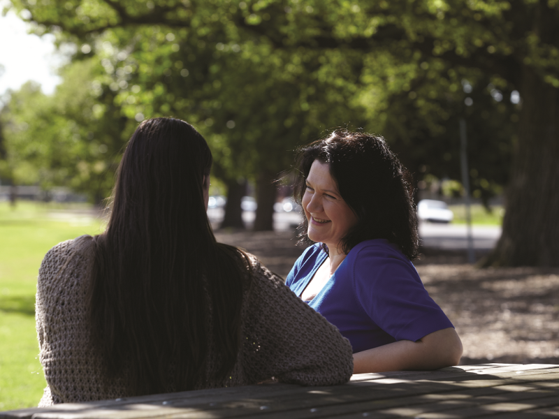 Two women chatting outside