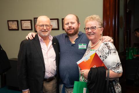 People standing arm in arm at the One Door Mental Health end of year celebration
