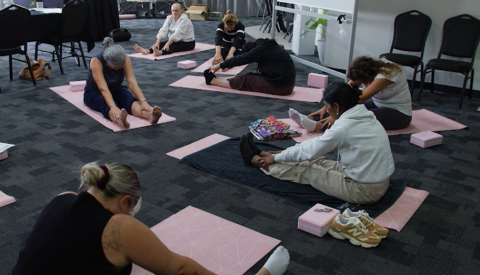 Women participating in yoga at the Mind Australia perimenopause retreat in Mackay, Queensland.